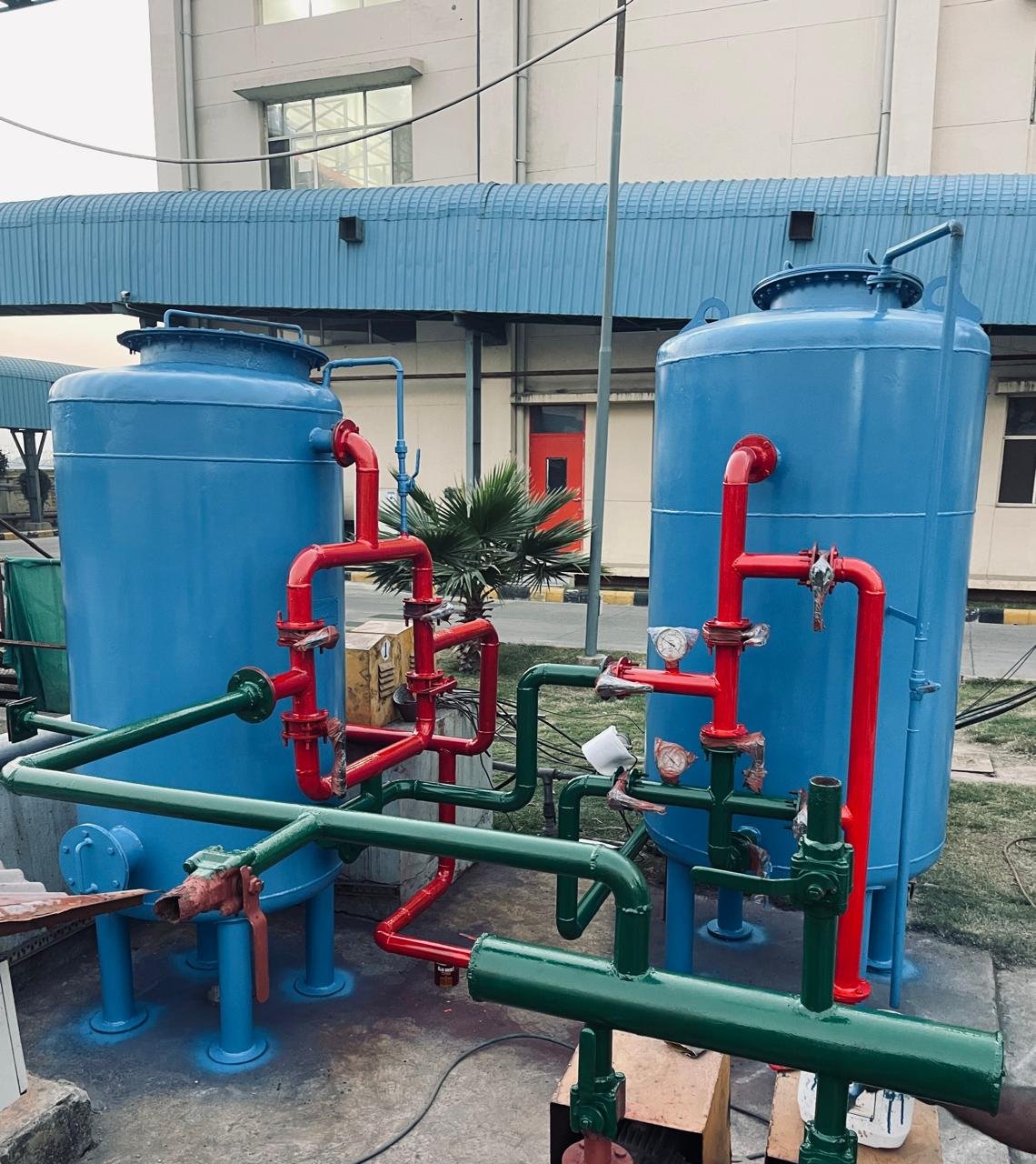 Blue MGF and ACF filter vessels with red face piping